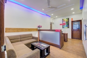 A modern living room with a sofa, a coffee table, and a TV. - Super Collection O Sunshine Near Inox (Pune)