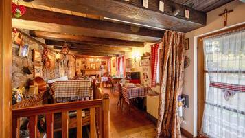 A rustic interior with wooden beams, stone walls, and traditional decor.
