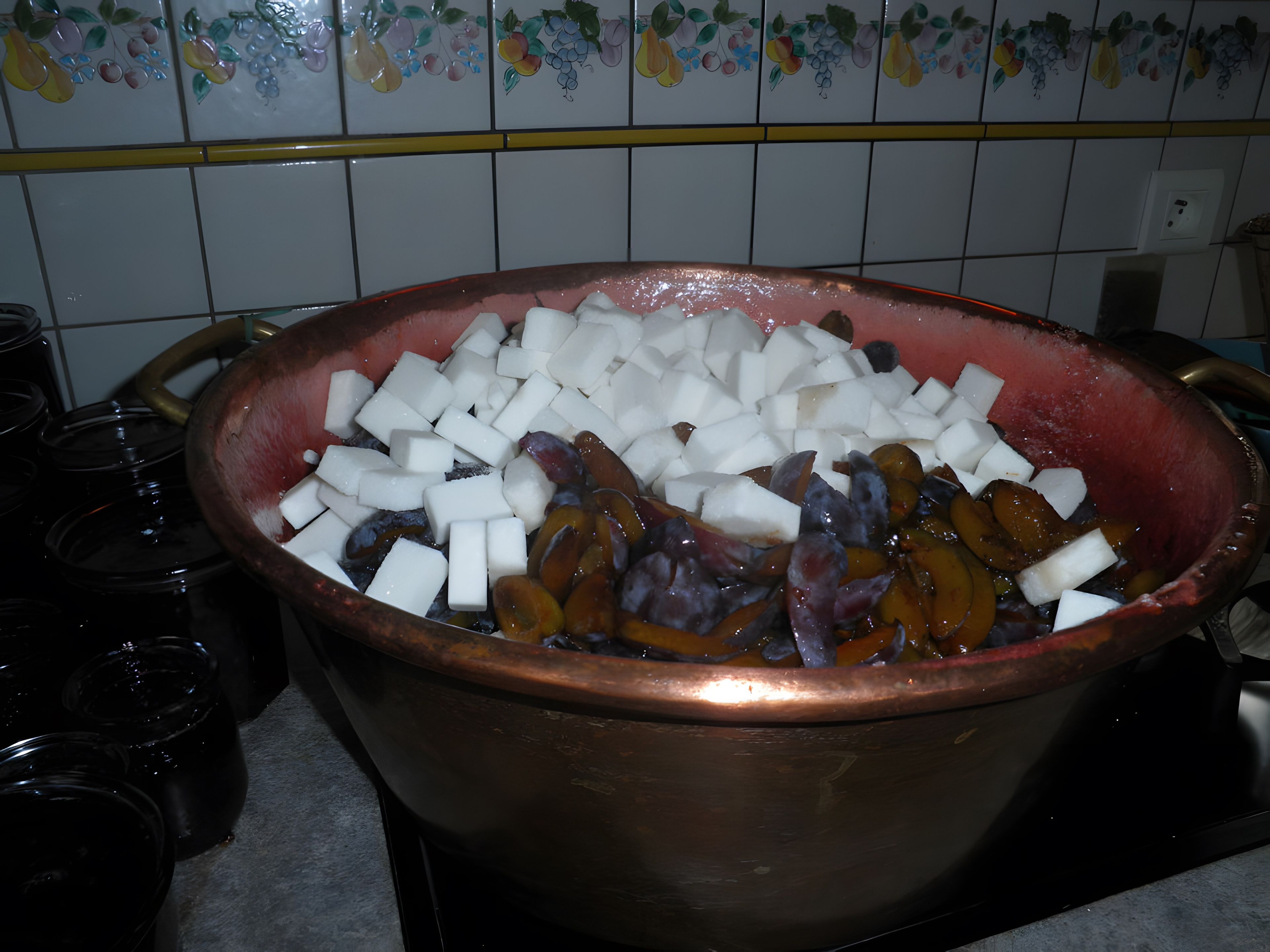 A copper pot filled with diced white and purple vegetables on a kitchen counter.