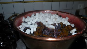 A copper pot filled with diced white and purple vegetables on a kitchen counter.