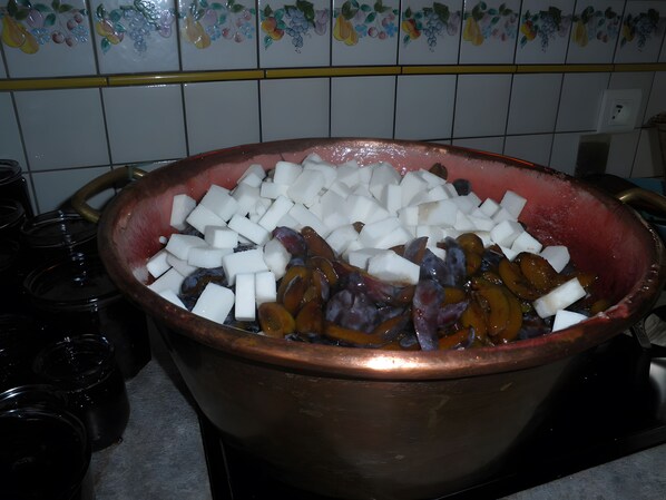 A copper pot filled with diced white and purple vegetables on a kitchen counter.