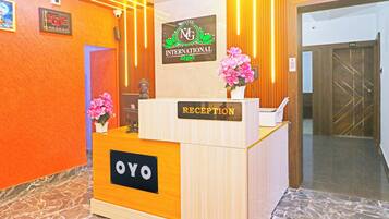 A hotel reception desk with a sign for 'Hotel International' and a 'Reception' sign.