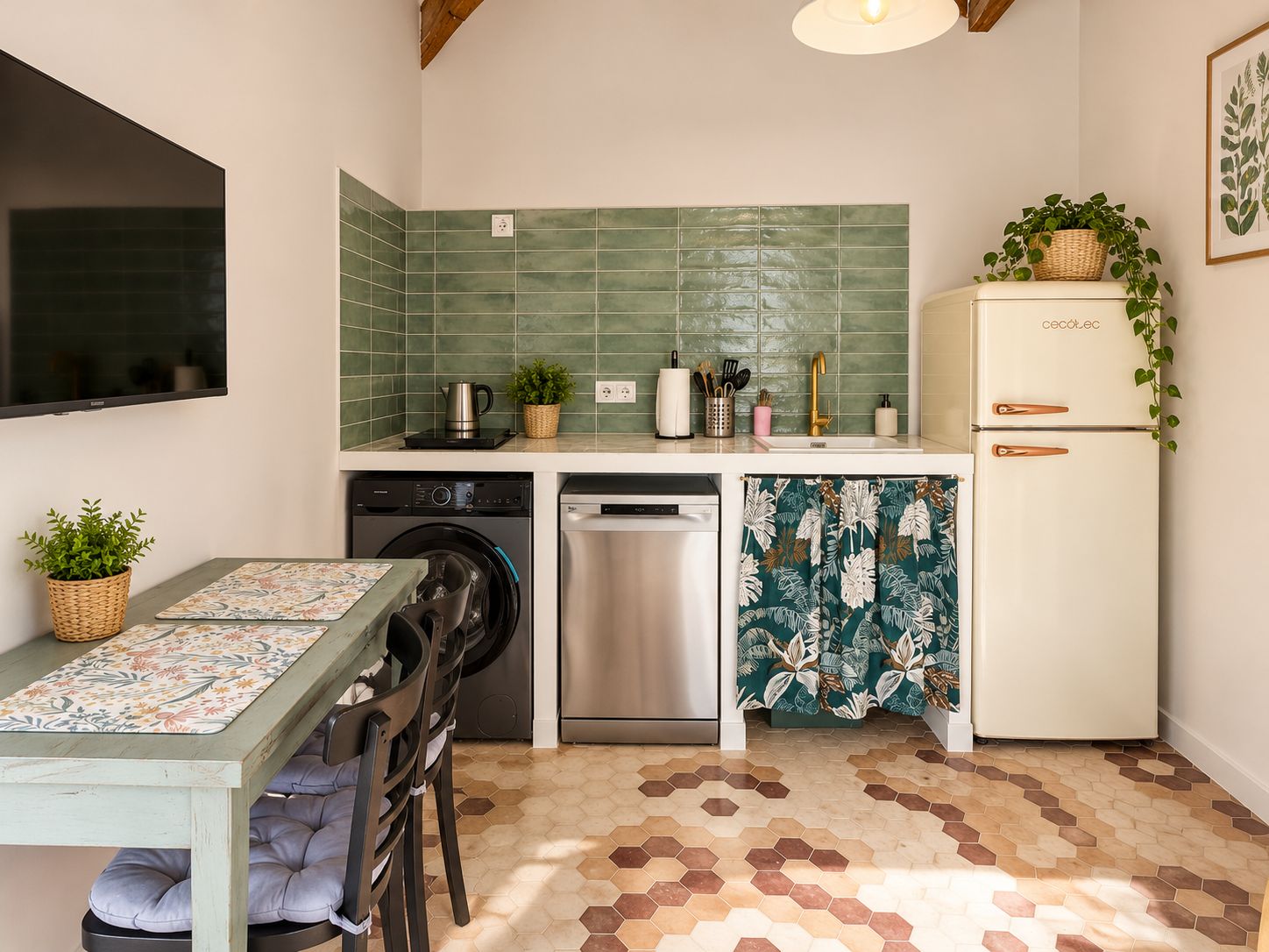 A compact kitchen with a washing machine, dishwasher, and a refrigerator.
