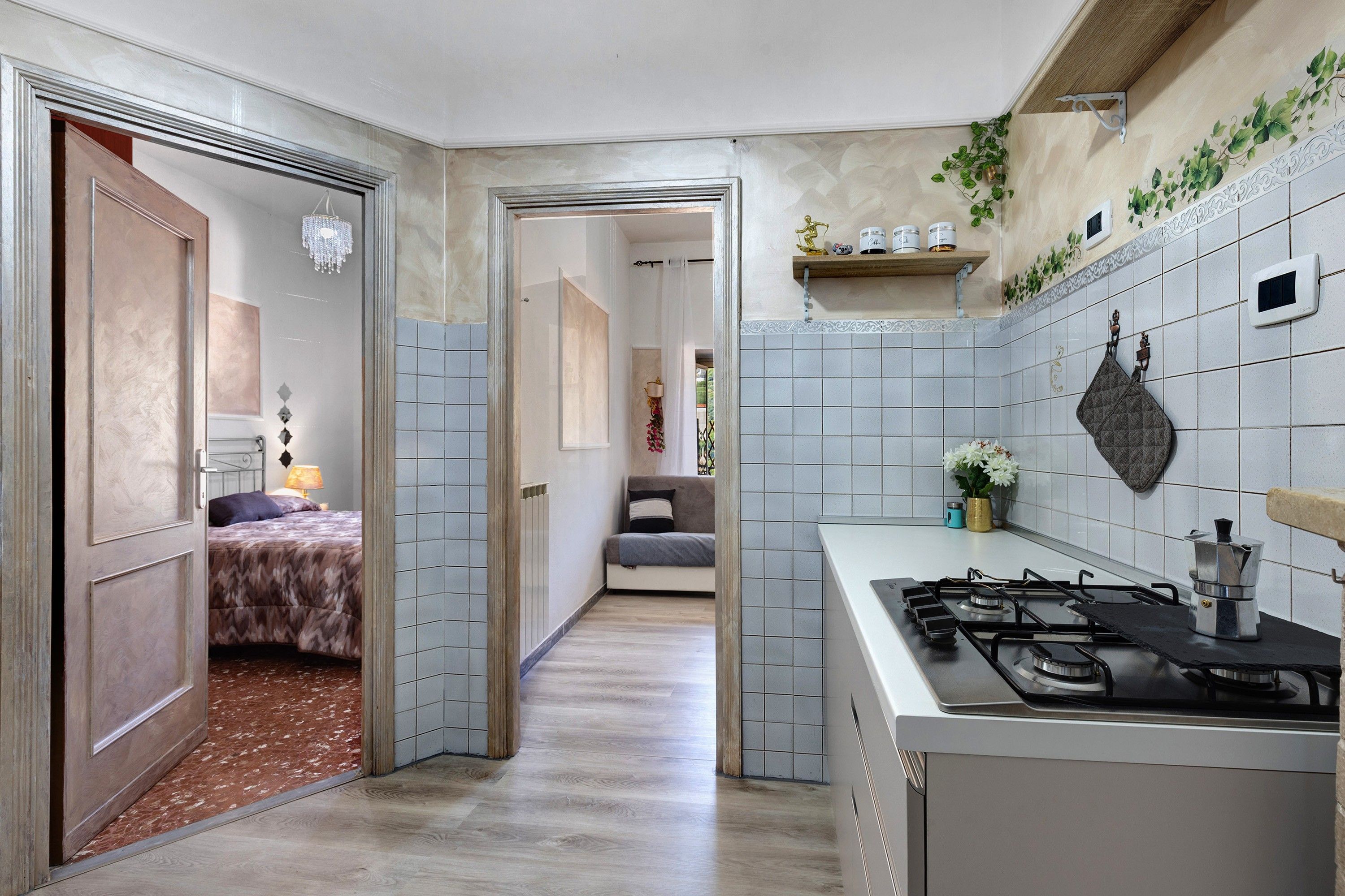 A modern kitchen with a gas stove, a coffee maker, and a tiled backsplash.