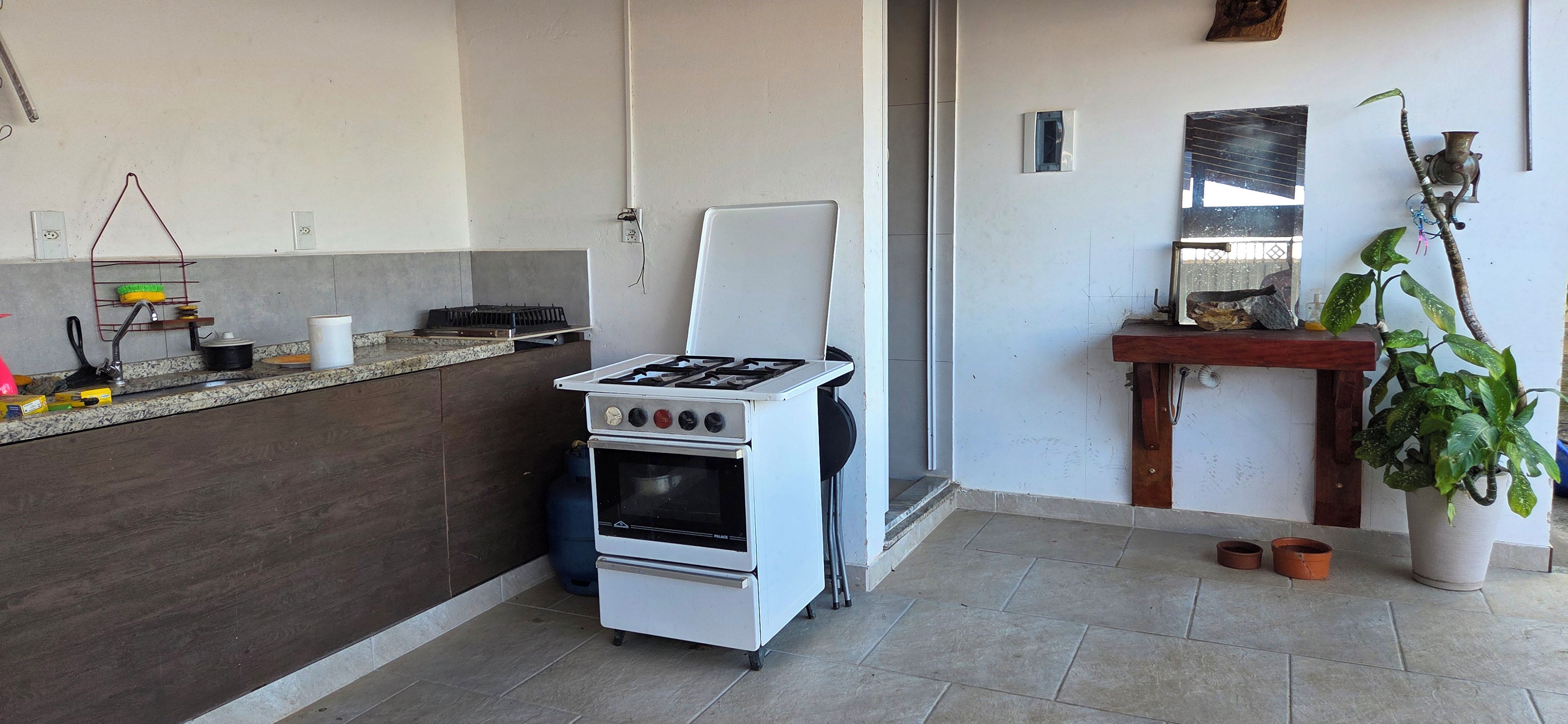 A compact kitchen with a gas stove, oven, and a small countertop.
