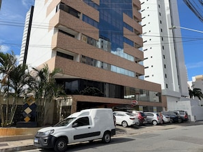 A multi-story building with a modern architectural design, featuring a mix of glass and brick facades. - Manaíra Apart Hotel  (João Pessoa)