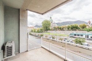 A balcony with a view of a church, a train, and a mountain. - Close To Everything 2 by Rent All Como (Como)