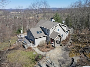 A two-story house with a deck, satellite dishes, and a stone pathway. - Sacred Dream Entire Property-Hot Tub Copake Lake (Craryville)