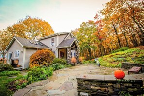 A two-story house with a stone foundation and a stone walkway leading to the entrance. - Sacred Dream Entire Property-Hot Tub Copake Lake (Craryville)