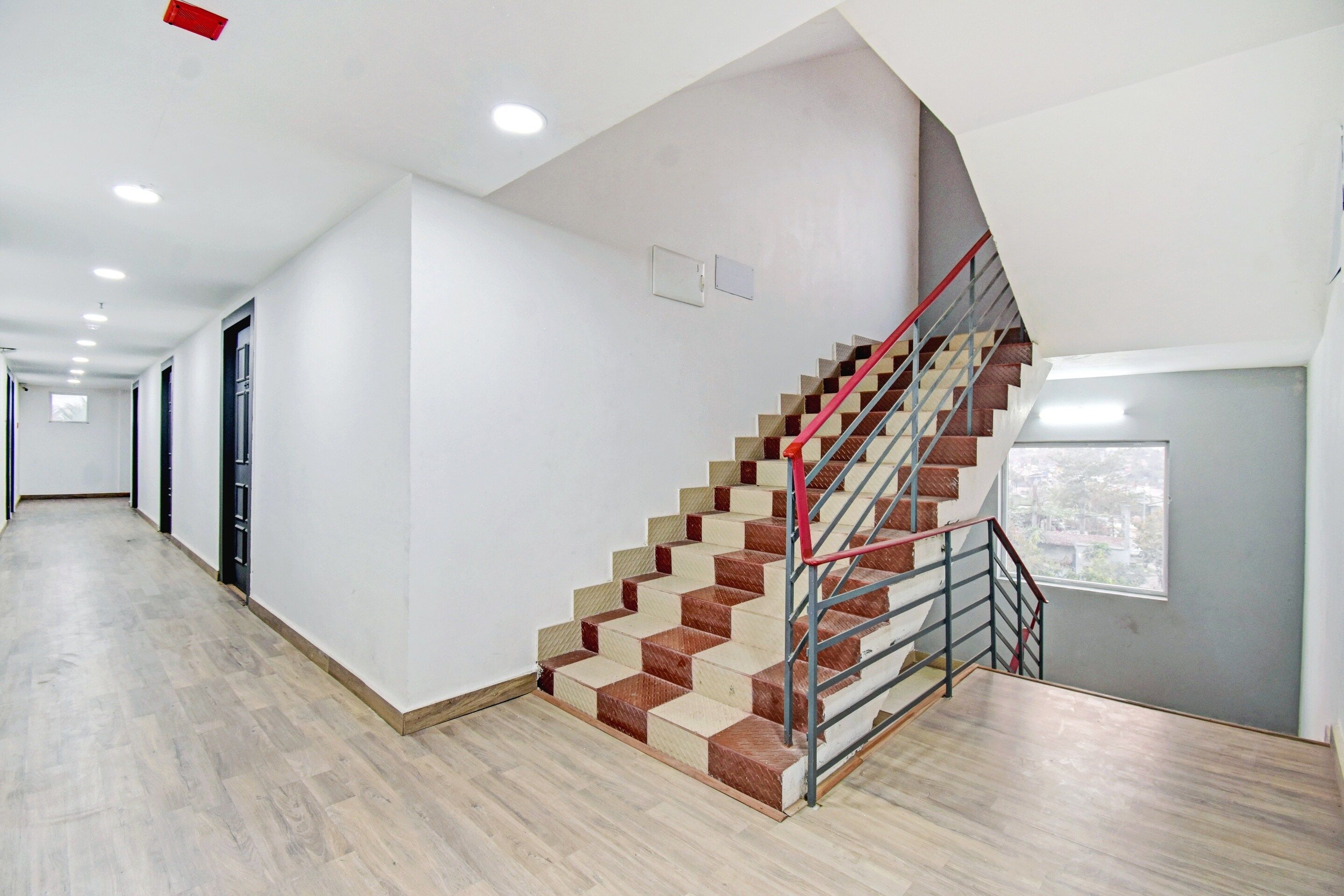 A spacious hallway with a staircase leading to a landing.