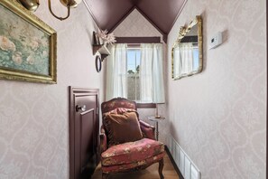 A narrow hallway with a door, a window with curtains, a mirror, and a floral-patterned chair. - Cozy 2 story guesthouse with private pool & spa - 3 minute walk to The Square (Georgetown)