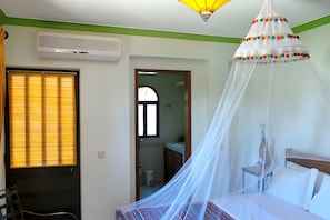 A bedroom with a bed, a window with blinds, an air conditioning unit, and a hanging light fixture. - Casa / villa - 6  stanze(con aria condizionata e bagno privato), 4-12 persone (Alvor)