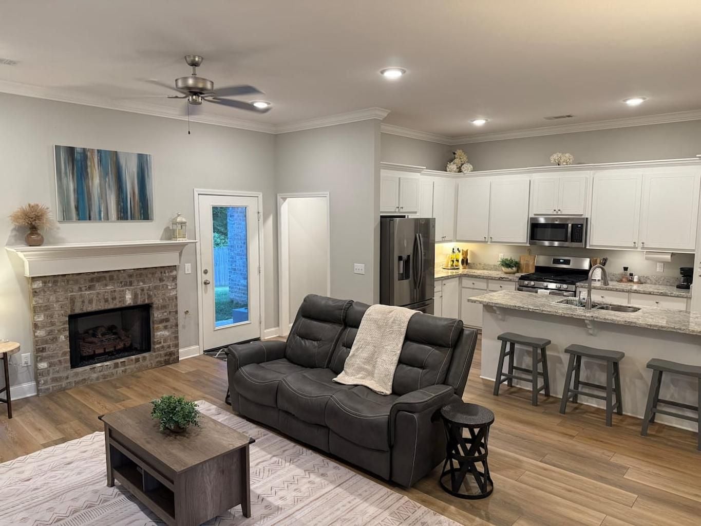 A modern living room with a fireplace, a sofa, and a coffee table.
