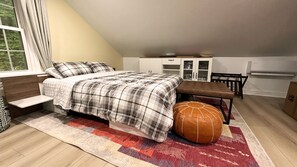 A bedroom with a bed, bench, ottoman, and a window with curtains. - 3-BR Chalet in Lake Harmony - Lakeview, 6 Queen Beds, Fireplace, Walk to Town (Lake Harmony)