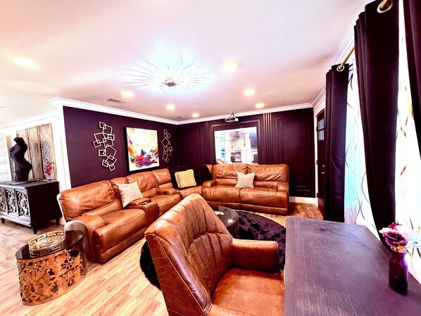 A living room with a sectional sofa, a coffee table, and decorative items.