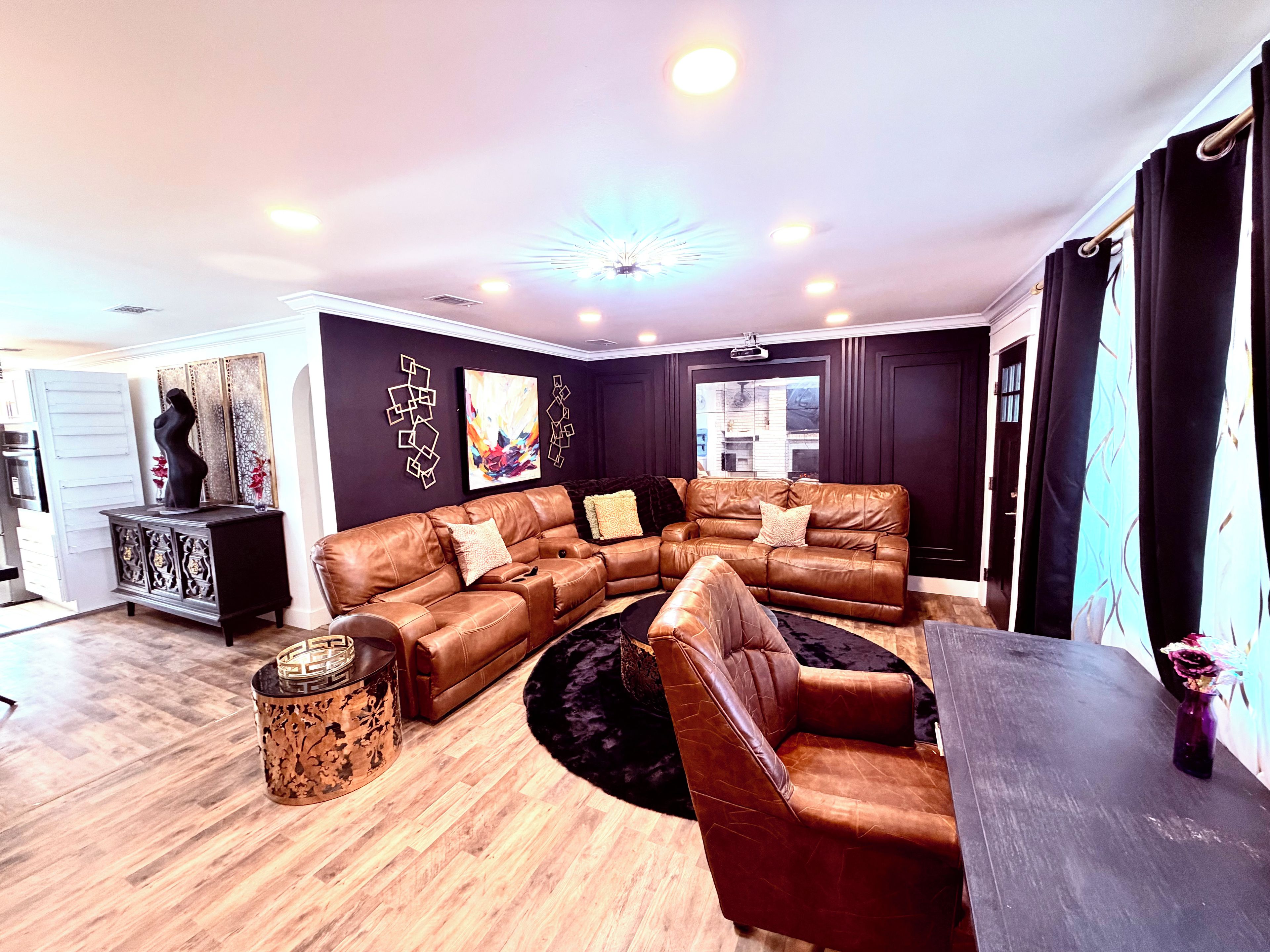 A living room with a sectional sofa, a coffee table, and a fireplace.