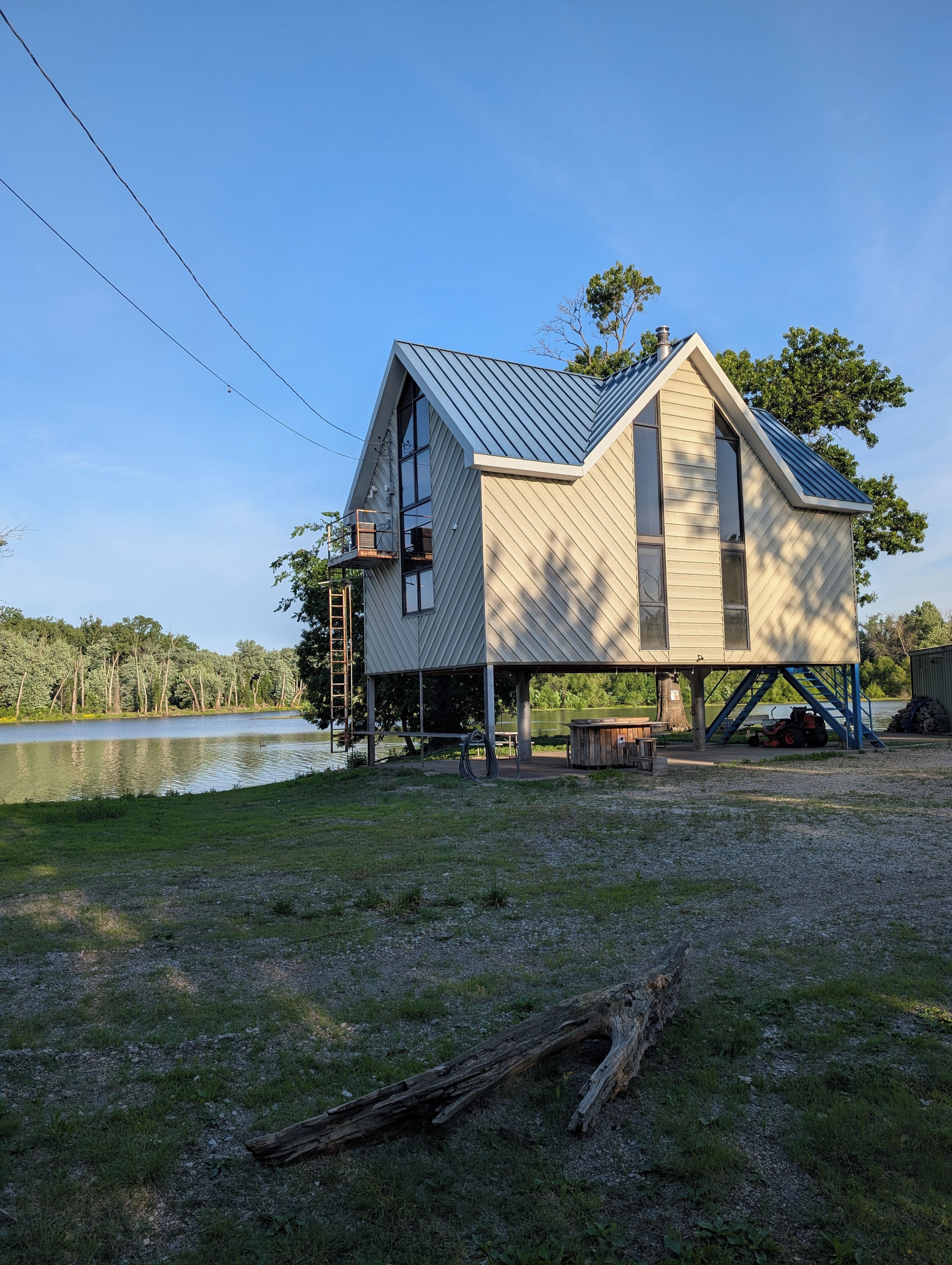 A house with a sloped roof, large windows, and a covered porch area.