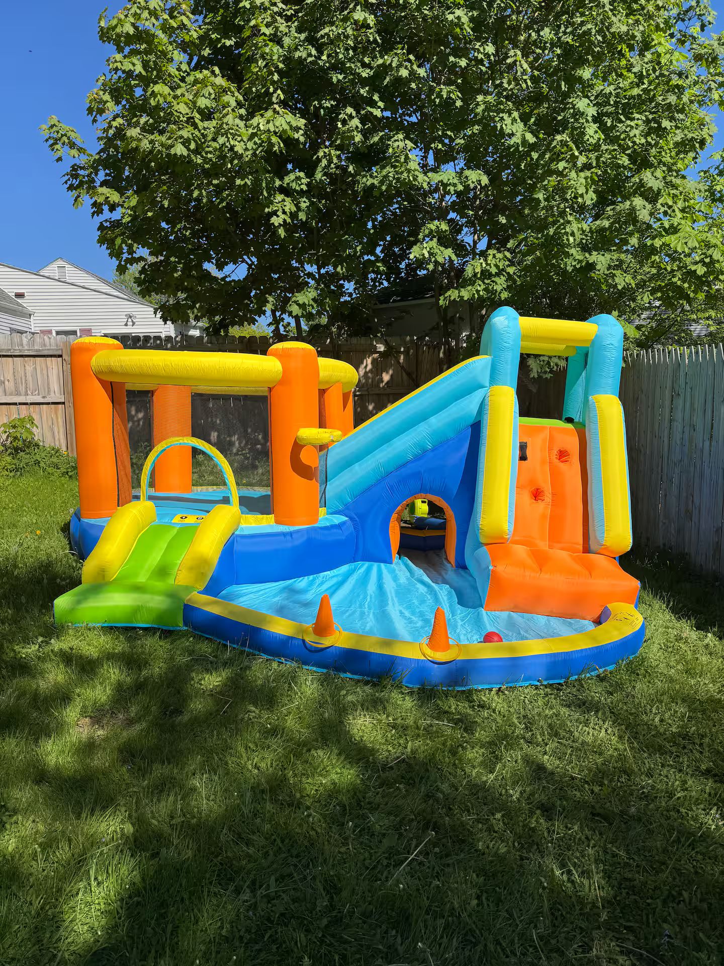 An inflatable play structure with slides and tunnels.