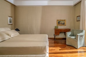 A hotel room with a large bed, a desk, a chair, and a painting on the wall. - Villa Arpino - Four Bedroom Villa, Sleeps 8 (Vico Equense)