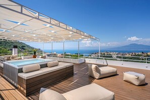 A rooftop terrace with a hot tub, seating area, and a view of the city and sea. - Villa Arpino - Four Bedroom Villa, Sleeps 8 (Vico Equense)