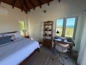 A bedroom with a bed, a desk, a chair, and a window with a view. - Casa del Mirage
Private coastal estate
Private pool & ocean views (Fraile)