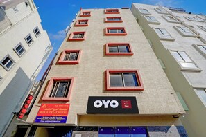 A hotel building with multiple windows and a sign for 'ROYAL TREAT HOTEL'. - Hotel O Royal Treat (Bangalore)