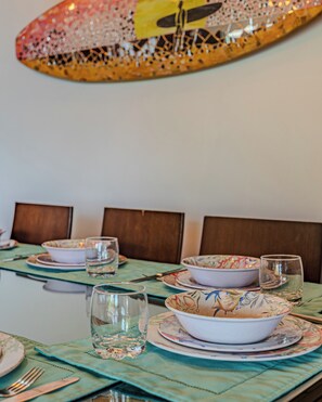 A dining table set with plates, bowls, glasses, and cutlery. - Villa Pacifica- Spectacular View, Gated Community (Savegre)