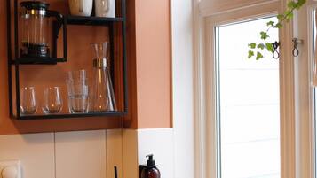 A kitchen with a black countertop, a sink, and a window with a view.