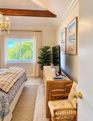 A bedroom with a bed, a desk with a computer, a chair, a window with curtains, and a plant. - Upscale Oceanfront Penthouse Villa Sleeps 4 Panoramic Ocean Views. (Sawgrass)