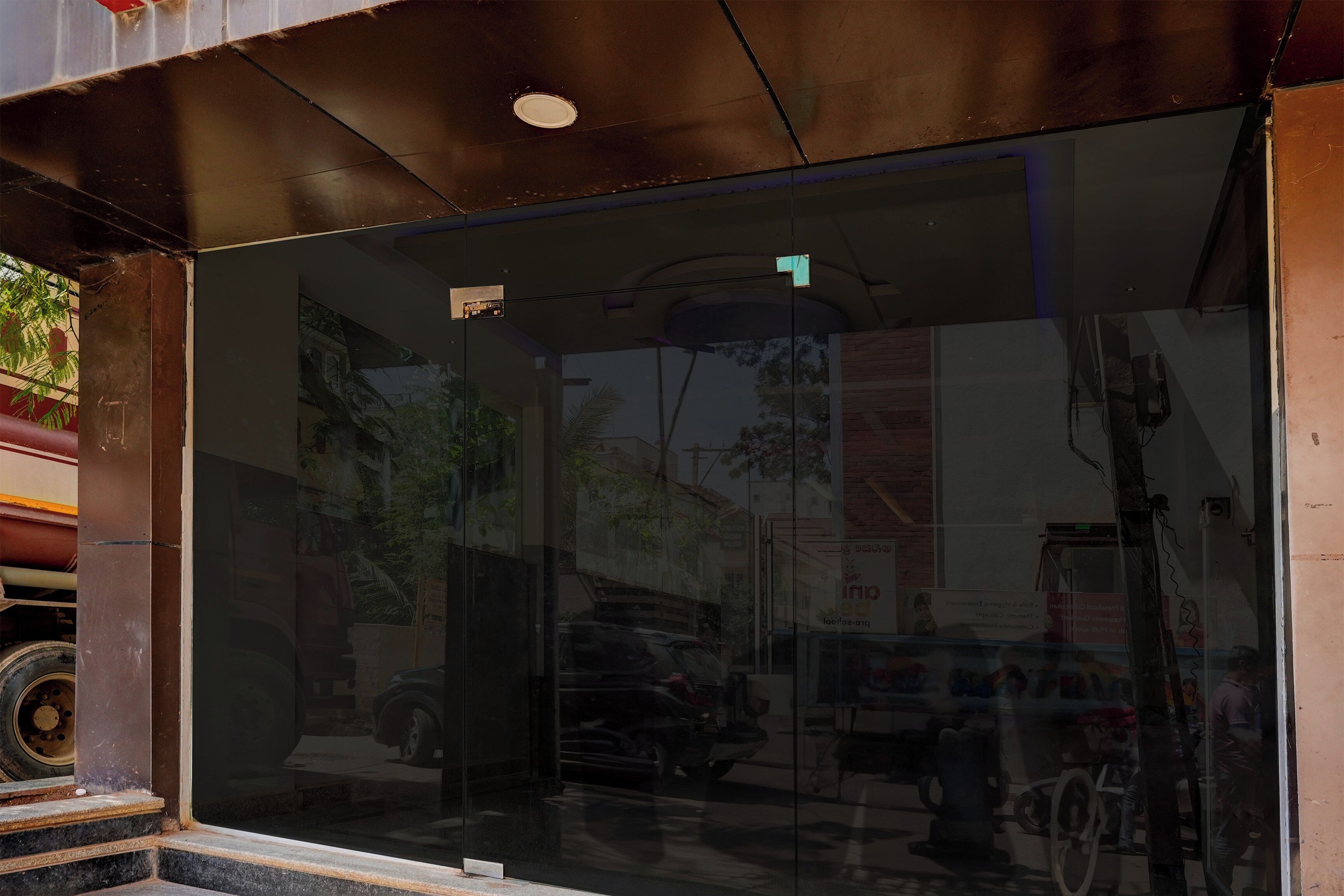 A building entrance with a glass door and a visible interior through the glass.