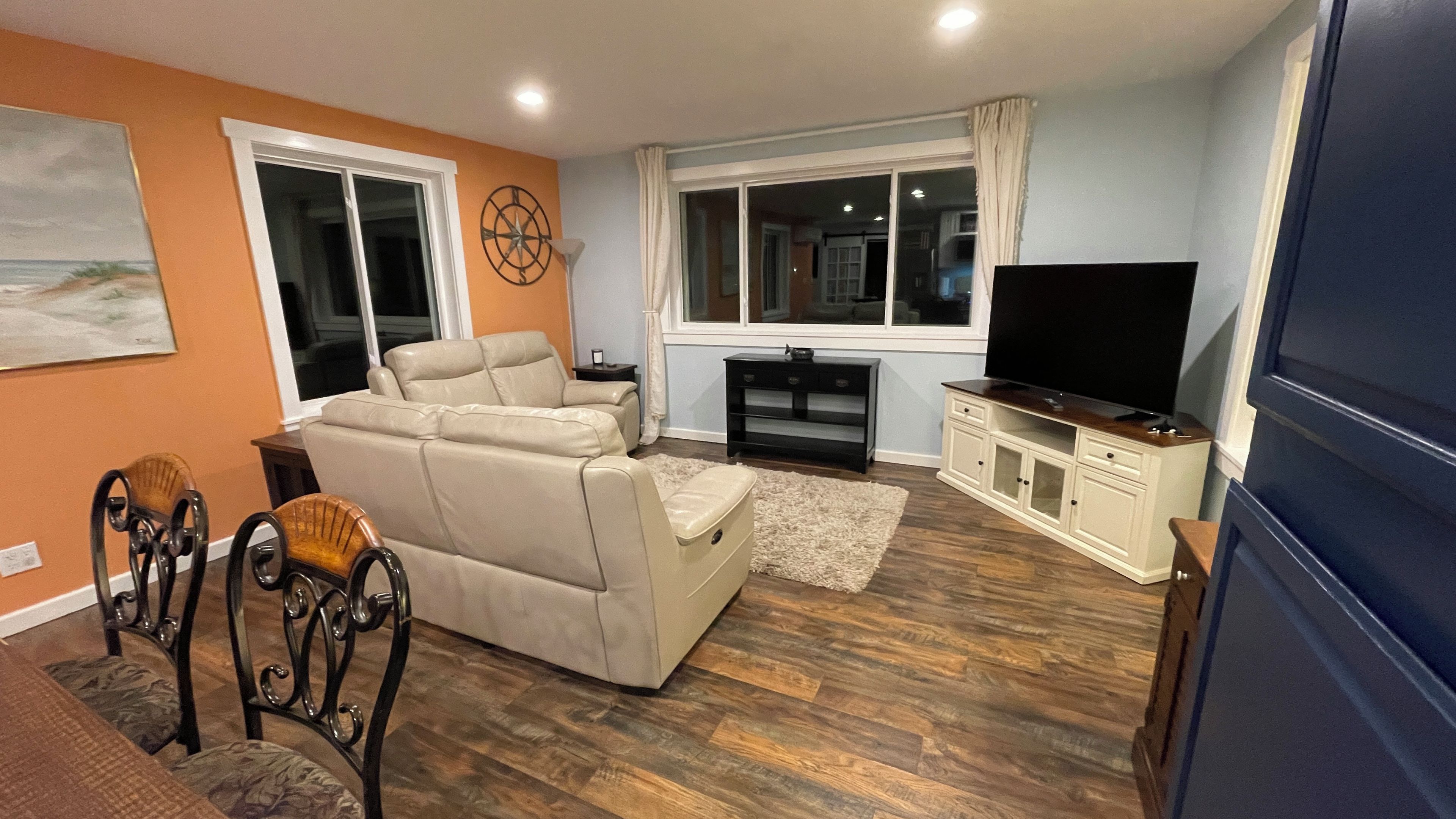 A living room with a sofa, a TV, and a cabinet.
