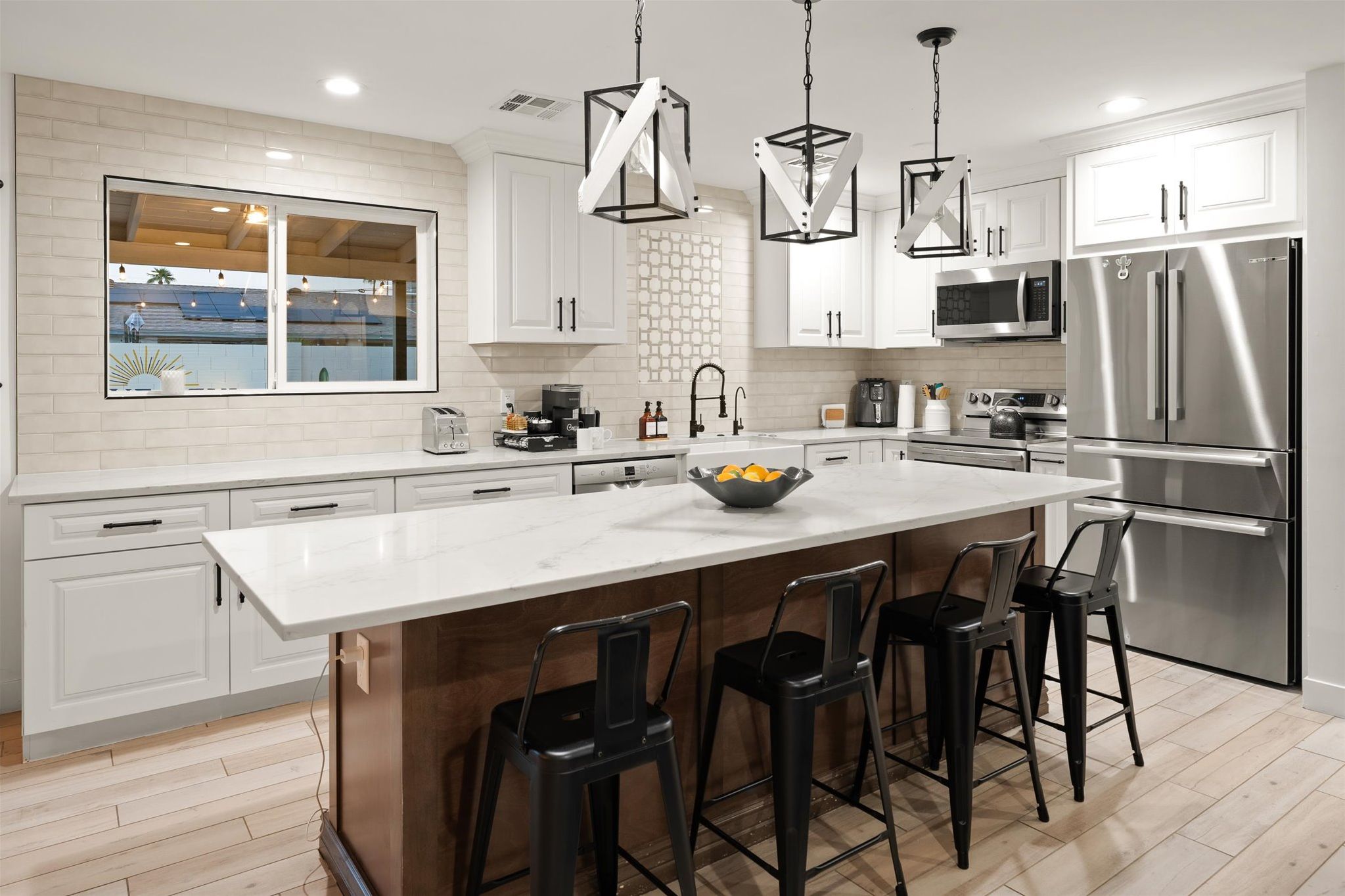 Bright modern kitchen with large island seating and stainless appliances