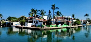 A waterfront property with multiple buildings, a dock, and boats. - Awesome studio with AC in the best location in Barra de Navidad (Barra de Navidad)