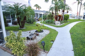 A landscaped pathway leading to a building with a sign indicating 'East Shore Resort.'