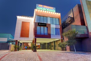 A building with a sign for 'NK Ivanta Luxury Rooms' and a 'Townhouse' sign.