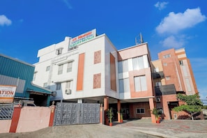 A multi-story building with a sign indicating it is part of the 'Luxury Rooms' group. - Townhouse NK Vivanta Luxury Rooms (Sriperumbudur)