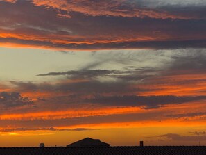 A sunset with a silhouette of a building and a mountain in the background. - Perfect 3-bedroom house with AC in  Cottonwood Ranch
Clubhouse with Pool/Hot Tub (Cottonwood)