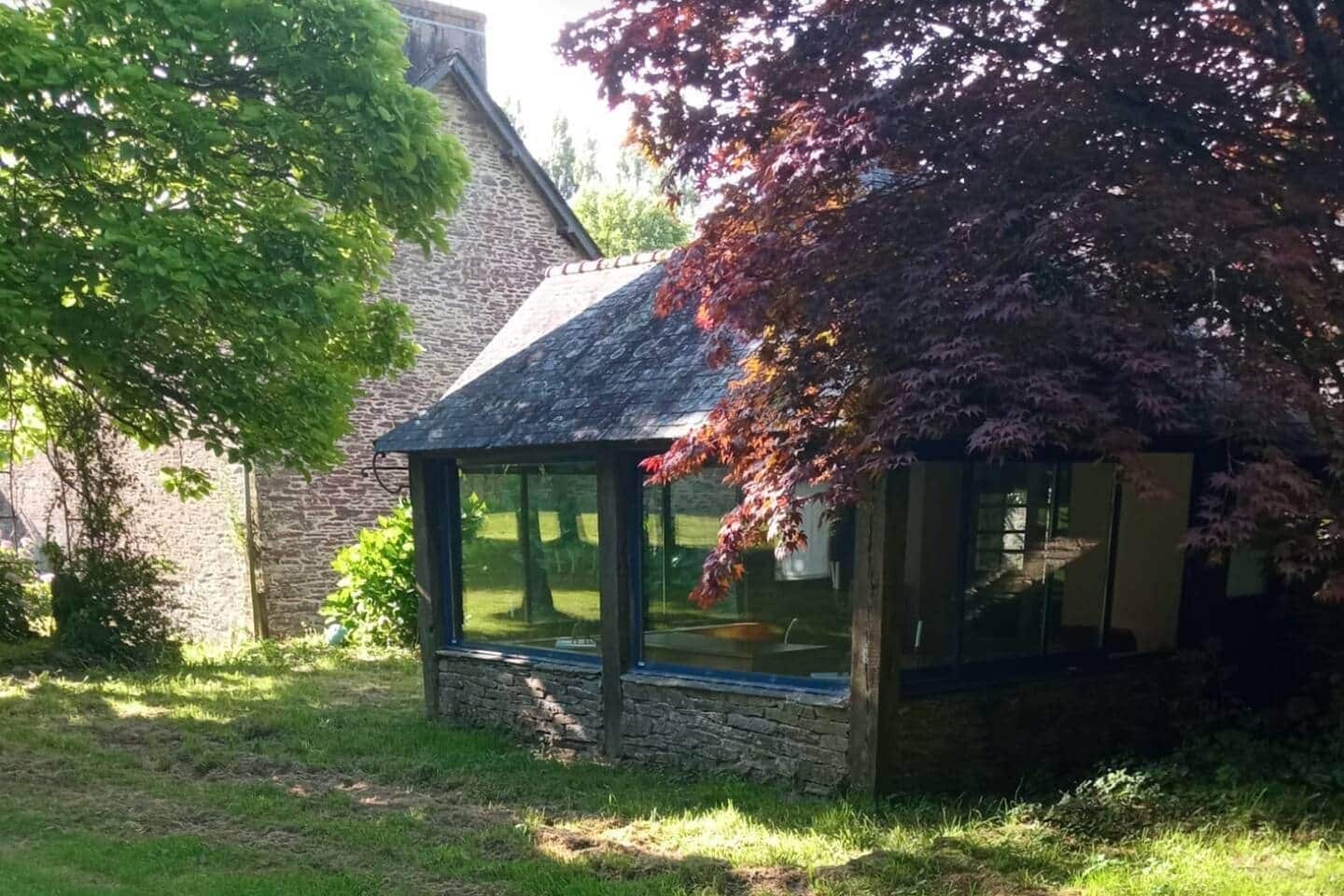 A stone building with a glass conservatory attached.
