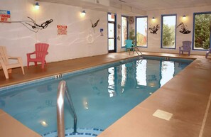 An indoor swimming pool with a 3 FT depth marker, safety signs, and chairs around the perimeter. - Cabin in Pigeon Forge - Welcome to Lucky Logs! (Pigeon Forge)