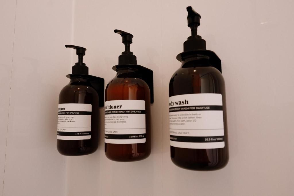 Three bottles of body wash, shampoo, and conditioner.