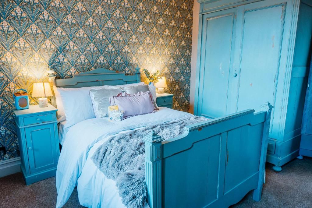 Une chambre à coucher comprenant un lit, des tables de chevet, une commode et une armoire.
