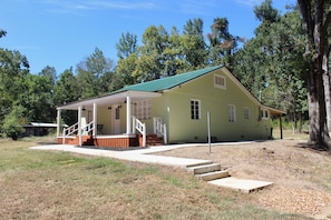 A single-story house with a porch, a front yard, and a driveway. - The Dettor House  (Sardis)