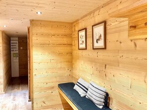 A wooden interior with a bench and framed artwork on the wall. - Renovated chalet, exceptional views - 8 guests (Les Gets)