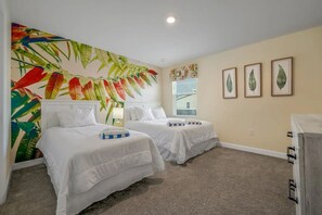 A hotel room with two beds, a large tropical mural, and three framed leaf artworks on the wall. - Luxury 9BR Villa w/ Private Pool & Themes (Kissimmee)