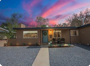 A modern house with a front porch, a garage, and a driveway. - Modern Farmhouse in Uptown ABQ (Albuquerque)