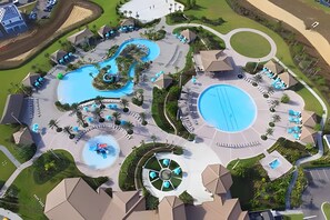 An aerial view of a resort with multiple swimming pools, lounge areas, and a central water feature. - 3BR Villa w/ Resort Access Near Disney (Davenport)