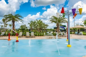 A pool area with water features, lounge chairs, and palm trees. - Storey Lake 4BR w/ Pool + Disney-themed Rooms (Kissimmee)