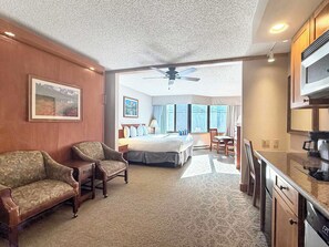 A hotel room with a bed, two armchairs, a desk, and a kitchenette. - NEW - Stellar Location with Hot Tub, Pool, Steam Room & Gym Acces, Pets Okay (Crested Butte)