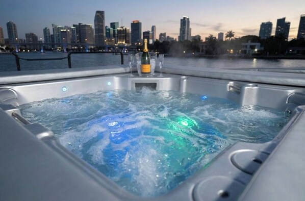 A hot tub with a city skyline view in the background.