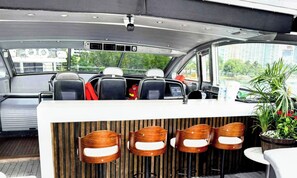 A bar area with wooden chairs and a counter.
